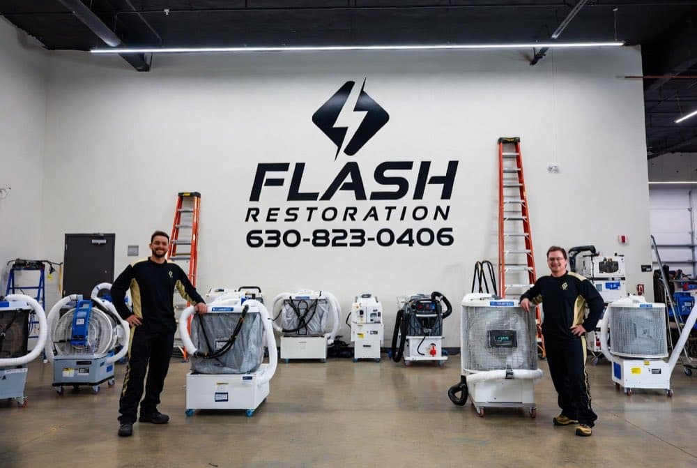 The Flash Restoration warehouse: branded wall, drying equipment fleet staged and ready