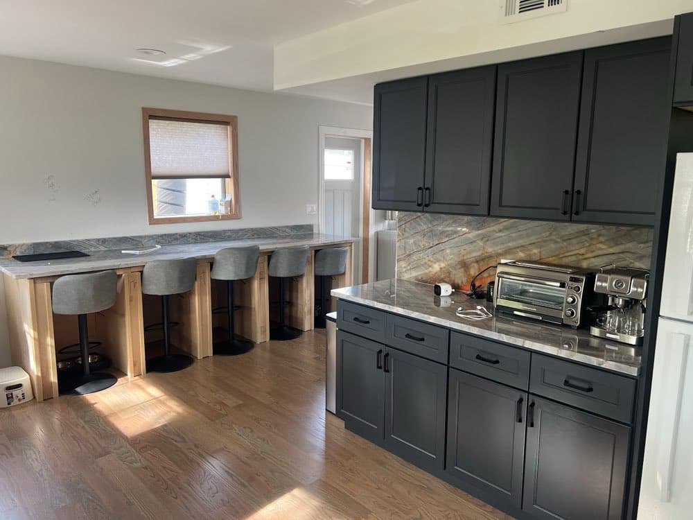 Rebuilt kitchen with bar seating after a water loss
